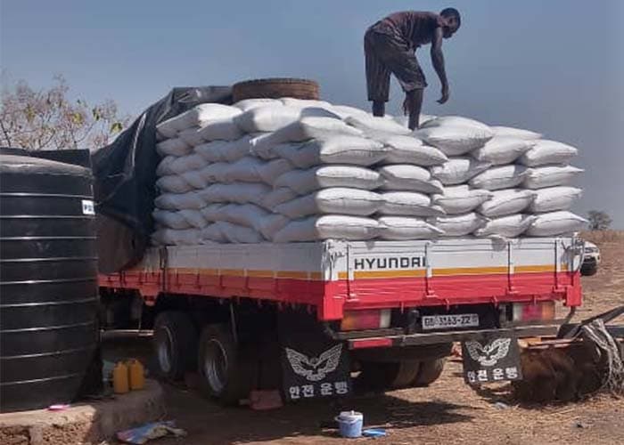 Harvested crop being loaded onto a truck for transport