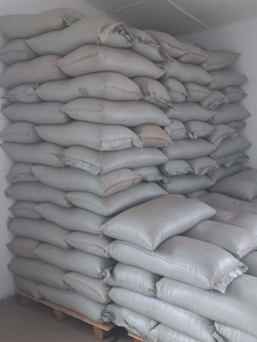 Stacked sacks of graded produce in a storage warehouse